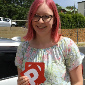 Young girl excited and holding her 'Passed assessment (P) plates by Bunbury driving school vehicle
